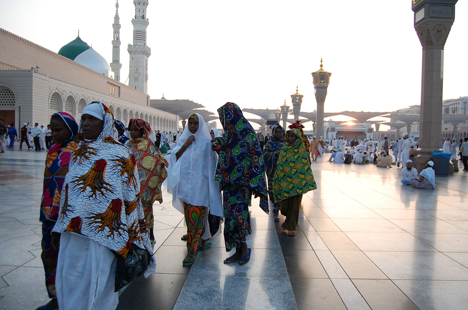 Colorfully dressed African women on the pilgrimage with the Prophet’s grave in the background