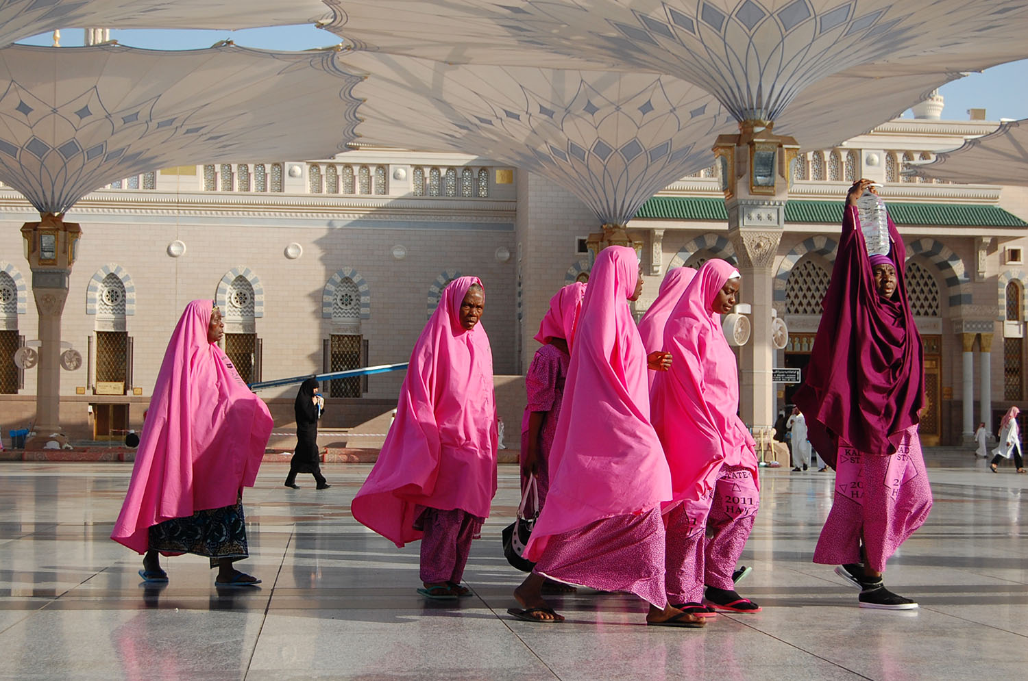 Like many, these African women pilgrims adopt a unique color code so they can find each other amongst millions.